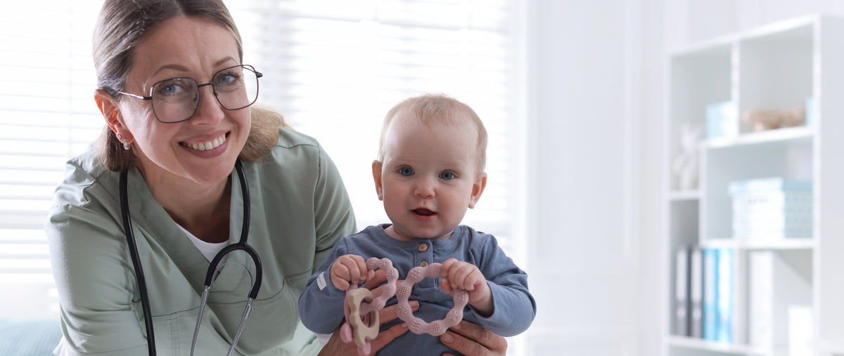 Speech therapy - Pediatric healthcare professional supporting a baby during a developmental assessment with interactive toys.